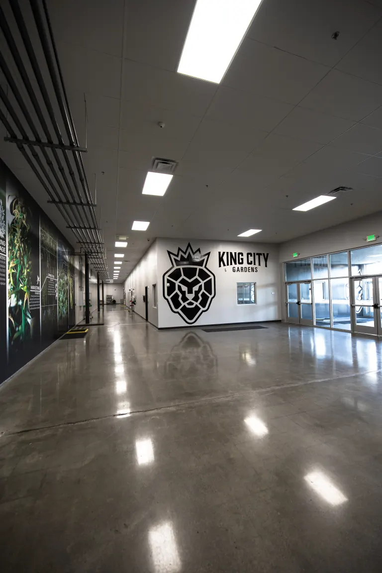 Looking down the main hallway of our Forest Park grow toward the lion crest and the King City Gardens name at its end