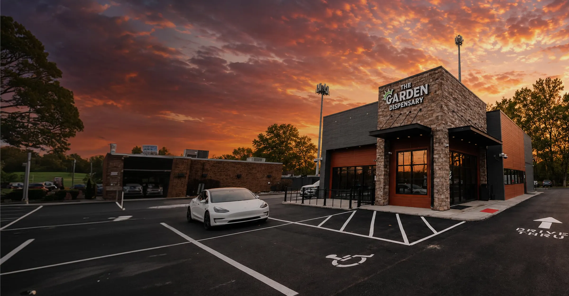 The Garden Sycamore Township at sunset, stone and brick with the sign lit